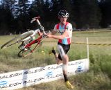 McDonald hits the barrier with speed. Raleigh Midsummer Night's cyclocross race. © Cyclocross Magazine