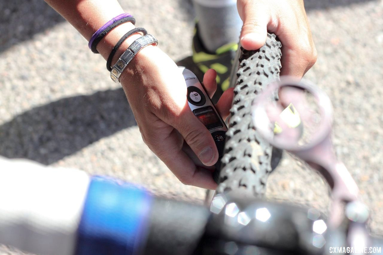 Mani checks her tire pressure pre-race at Raleigh Midsummer Nights Cross. © Cyclocross Magazine