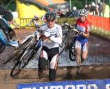 Kupfernagel (l) and Van Den Brand going over the barriers in the mud. ? Bart Hazen