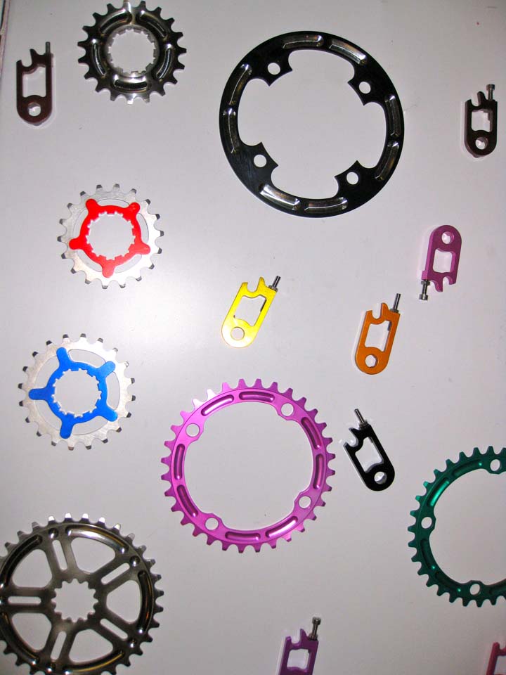 Home Brewed Components gets the gratuitous eye candy award for their array of anodized chainrings, ring guards, cogs and nut tuggers. Though not listed on his website, owner Dan Wilcox indicated that he?d be happy to make anodized chainring guards for up to 42 teeth rings in either 110 or 130 BCD sizes. ? Dave Lawson