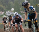 Jodi Connolly of the Blue Rooster cycling team looks over as the men&#039;s field approaches to her right © Karen Johanson