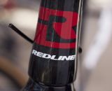 We got an exclusive preview of Redline 2013 products, but currently this bold head badge is all we're allowed to show you. Sea Otter 2012. ©Cyclocross Magazine