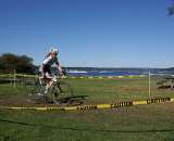 Women&#039;s racer readies for the barriers with Hydro&#039;s in background. by Kenton Berg
