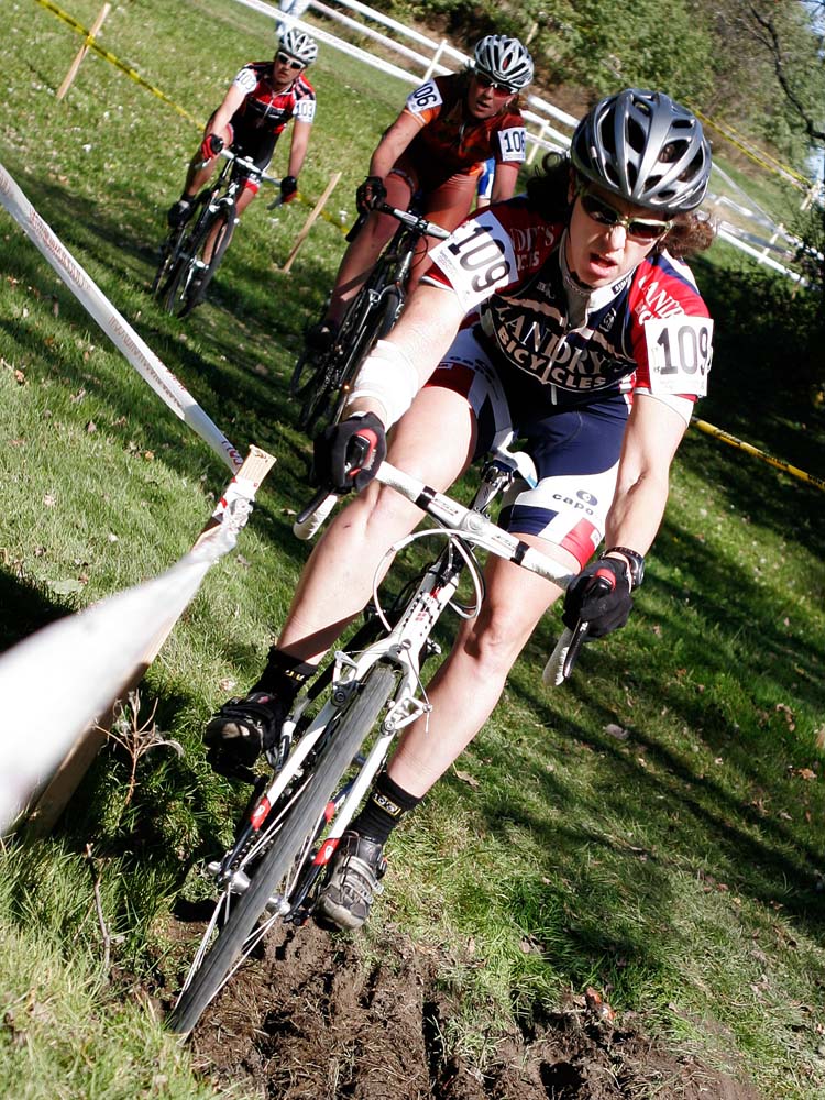 Sara Bresnick-Zocchi hugs the course tape through the ditch crossing in the elite women\'s race. ? Mike Clark
