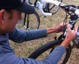 Trebon putting a Pioneer S-Mustache sticker on his head tube.  