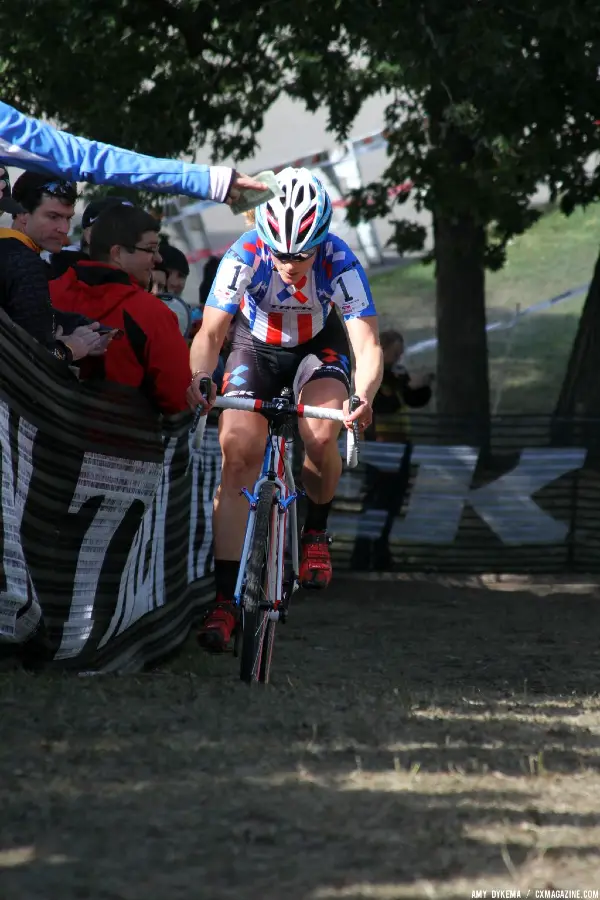 Katie Compton in the lead on the first lap, ignores a dollar hand up. © Amy Dykema