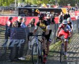 Brian Matter (RACC p/b GearGrinder), Troy Wells (Team Clif Bar)  and Tristan Schouten (Optum p/b Kelly Benefit Strategies) approach the barriers. © Amy Dykema