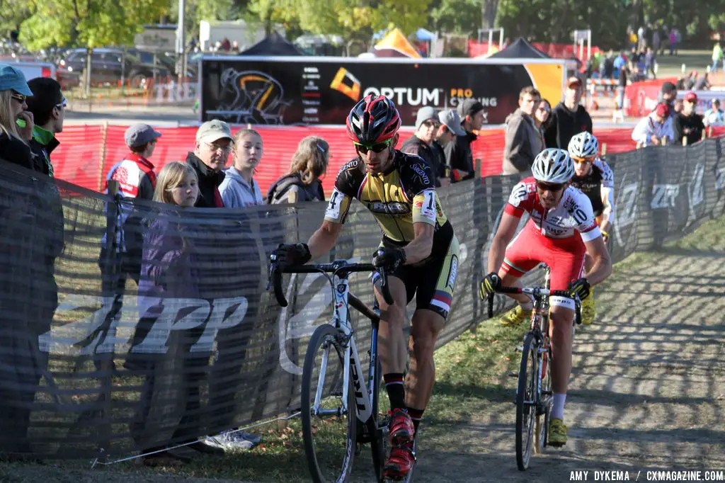 Brian Matter (RACC p/b GearGrinder), Troy Wells (Team Clif Bar)  and Tristan Schouten (Optum p/b Kelly Benefit Strategies) approach the barriers. © Amy Dykema