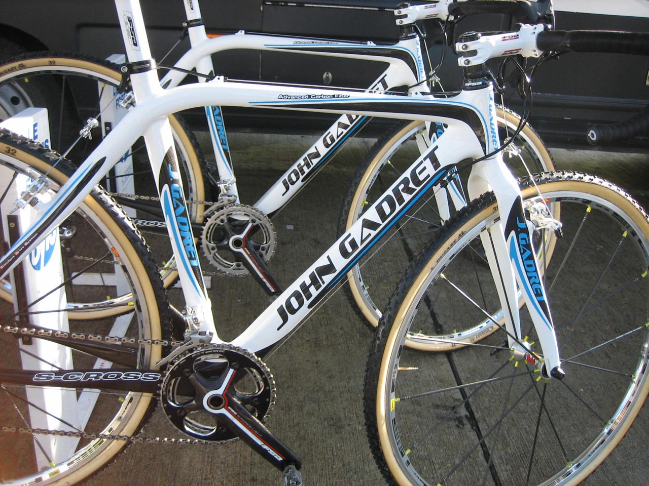 John Gadret bikes, ready to roll Muddy post-race legs ? Christine Vardaros