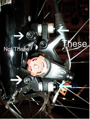 With the brake attached to the bike loosen the caliper mounting bolts. Jason Gardner