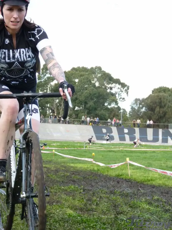 Jess Steger looking concerned as she rides through the mud. © David Cunningham