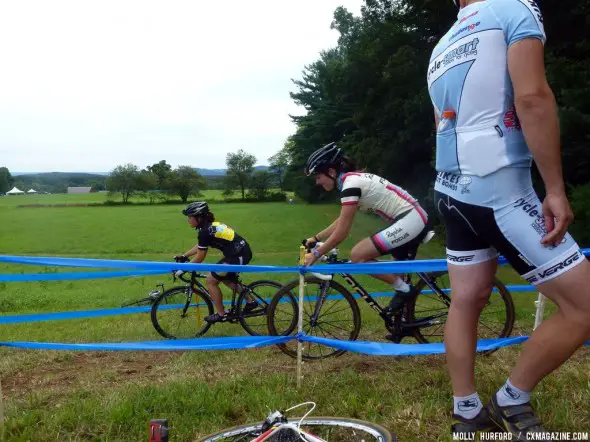 New Rapha-Focus member Gabby Day shows a Hup United rider the best lines for cornering on an off-camber. © Cyclocross Magazine