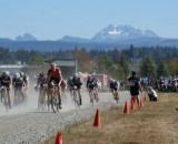 Three Fingers Mountain looms large behind the Men' Elite field as they start their race - credit Kenton Berg