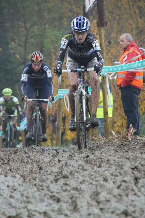 Riders head through the muck. © Bram van Lent