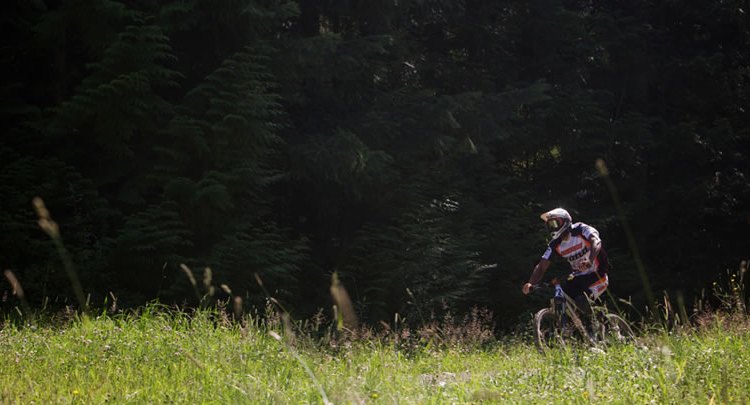 Slaven racing downhill. Photo Courtesy of the Kona Factory Team