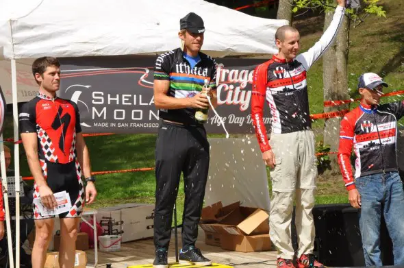 Brad White pops the champagne at last year's Ithaca GP_ he is flanked by Sven Baumann and Tom Burke (photo Curt Potocki)