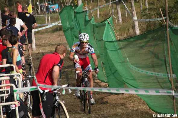 Feeding was important for many racers due to the heat. Yorben van Tichelt taking a bottle in the pit. Qiansen Trophy UCI C2 Cyclocross Event. © Cyclocross Magazine