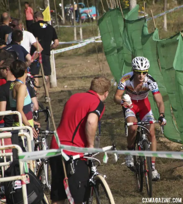 Feeding was important for many racers due to the heat. Yorben van Tichelt taking a bottle in the pit. Qiansen Trophy UCI C2 Cyclocross Event. © Cyclocross Magazine