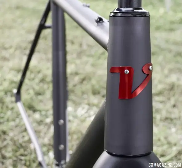 The oversized headtube accepts tapered steerer forks and features an aluminum headbadge - 2014 Van Dessel Aloominator cyclocross frame. © Cyclocross Magazine Oversized headtube accepts taperered steerer forks on 2014 Van Dessel Aloominator cyclocross frame. © Cyclocross Magazine