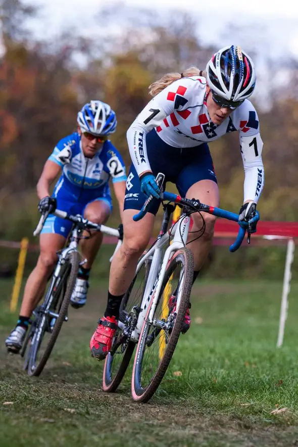 Katie Compton, foreground, out of the saddle on the attack, followed by Katerina Nash. © Kent Baumgardt