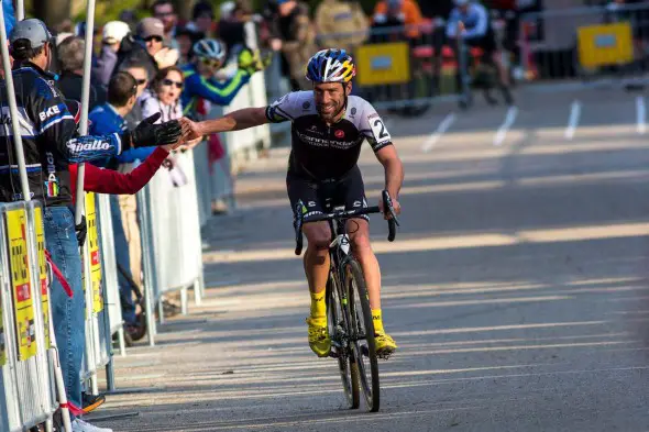 Tim Johnson high-five's fans on the way to the win. © Kent Baumgardt