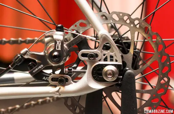 All-City Cycles' Nature Boy Disc has a cleverly designed, sliding post disc brake mount that also serves to adjust wheel placement and chain tension, via a 3mm Allen key. The Hennepin Bridge remains in the dropout. © Cyclocross Magazine