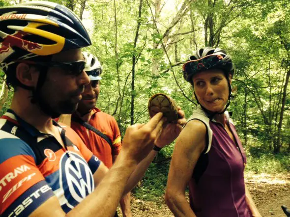Tim Johnson and Jamie Kripke inspect one of the many turtles on the Katy Trail in Missouri as Johnson's wife, Lyne Bessette, makes a funny face. 