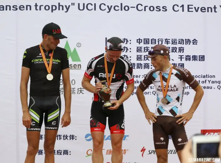 Thijs Al's first place trophy draws envy from Steve Chainel (third, right) and Ryan Trebon (second, left).  2014 Qiansen Trophy Cyclocross Race. © Cyclocross Magazine