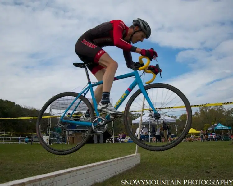 Sven Baumann (Lake Orion, MI) bunny hops a barrier in front of the crape tent on his way to victory in the Men's 1/2/3 race.