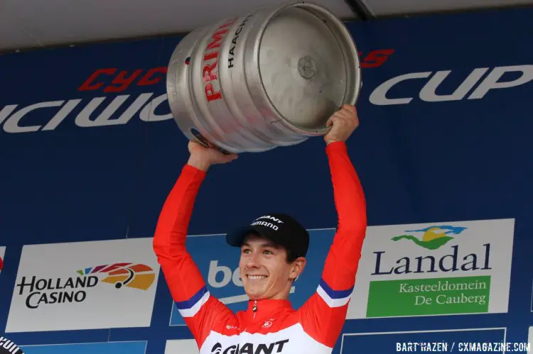 Valkenburg showing the proper way to give an elite rider beer at a cyclocross race. © Bart Hazen