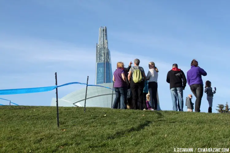 Spectators came to see the Kick Cancer Cyclocross activities, with Winnipeg’s Museum of Human Rights soaring in the background. © Andrew Reimann