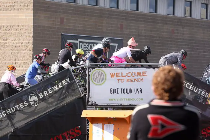 The men's field goes up and over the ramp, provding equal parts tricks and treats for the crowds. © Pat Malach