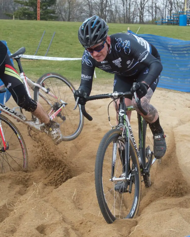 James Brady (Chicago, IL) carves sand while another Men's Cat 3 rider careens  toward the adjacent volleyball court.  © SnowyMountain Photography