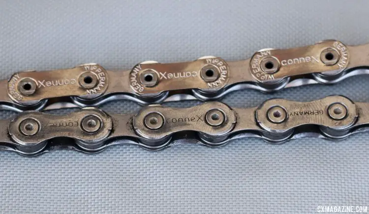 ConneX old (top) vs. new (bottom) 11-speed chains (a hollow pin version is sitll available). The chamfered nickel-plated steel plates on the newer chain differentiates the two models. Sea Otter Classic 2015. © Cyclocross Magazine