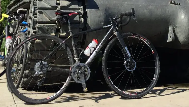 Amanda Nauman’s Daily Bikes prototype cyclocross bike in front of a tank. © Amanda Nauman