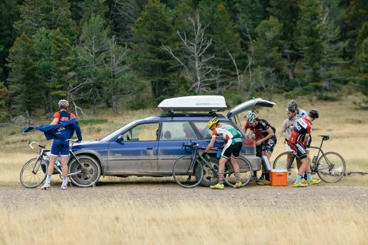 As a summer storm brews, riders and coaches scurry for bottles and rain capes to begin the descent off of Mullen Pass. © Tom Robertson.