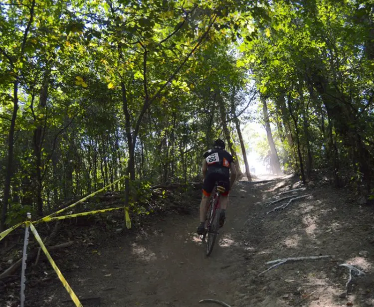 Michael Patton (Chicago, IL) climbs out of a wooded section during the Single Speed race.