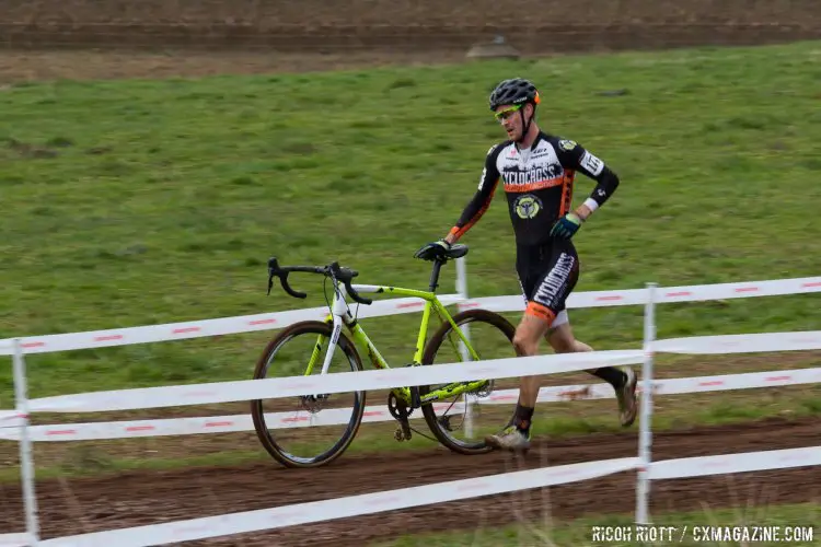 Andrew Dillman runs to the pits with derailleur issues