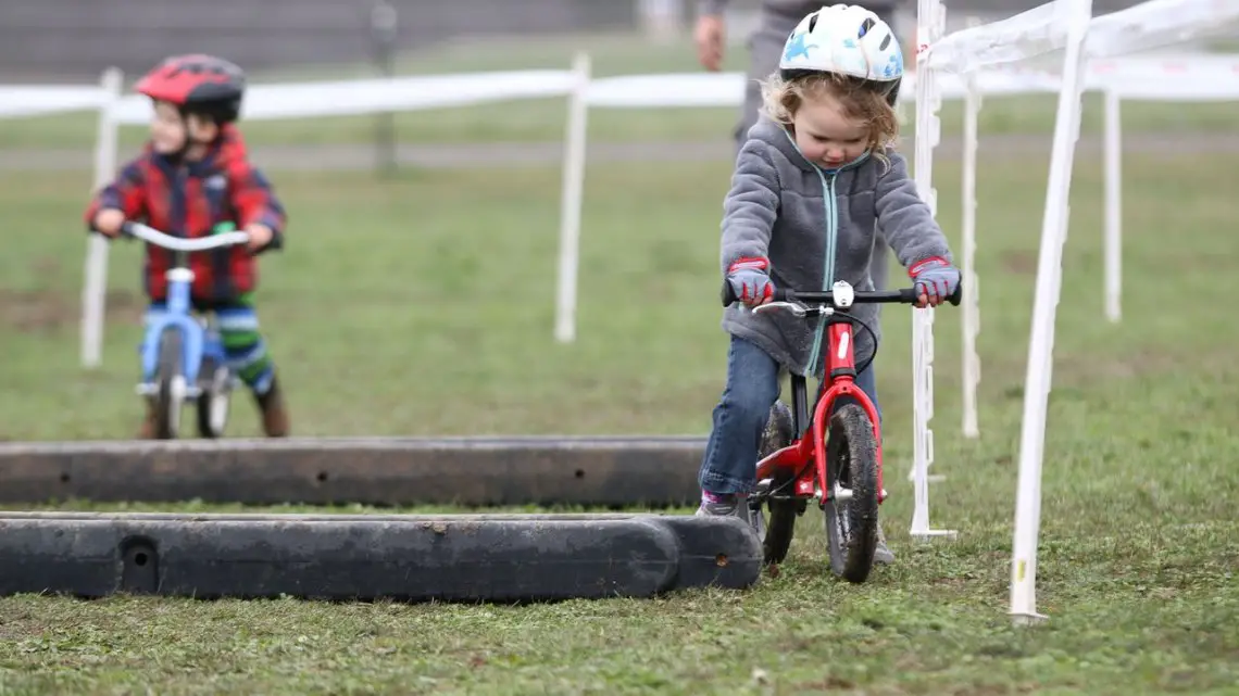 Racing is finding the fastest route between the tape, some say. Kid Cross Race, 2016 Cyclocross National Championships. © Cyclocross Magazine