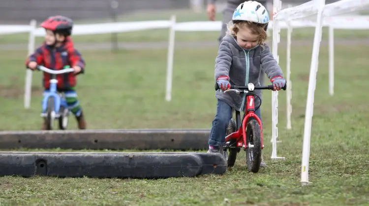 Racing is finding the fastest route between the tape, some say. Kid Cross Race, 2016 Cyclocross National Championships. © Cyclocross Magazine