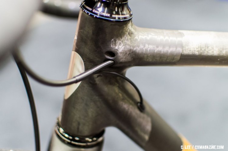 The extra hole is plumbed for a front derailleur shift cable. NAHBS 2016. © Clifford Lee / Cyclocross Magazine