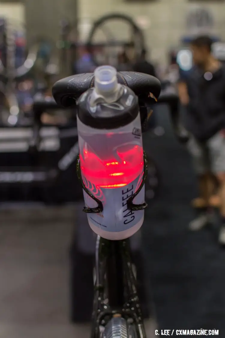 Calfee's Firefly 'aero' behind the seat bottle holder with accelerometer activated switch tail light, makes the bottle glow. NAHBS 2016. © Clifford Lee / Cyclocross Magazine