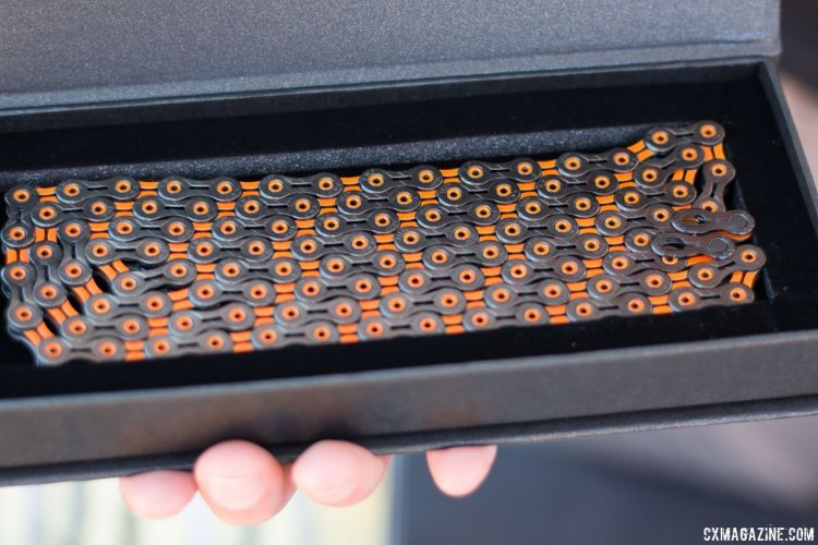 KMC $140 DLC 11 (Diamond-Like Coating) is KMC's top-of-the-line chain, and comes in a new black and orange color scheme that matches CXM's logo. Regardless of colors, the chain is said to offer 5,000 miles, compared to 3,000 miles for a standard chain (road conditions). Sea Otter Classic 2016. © Cyclocross Magazine