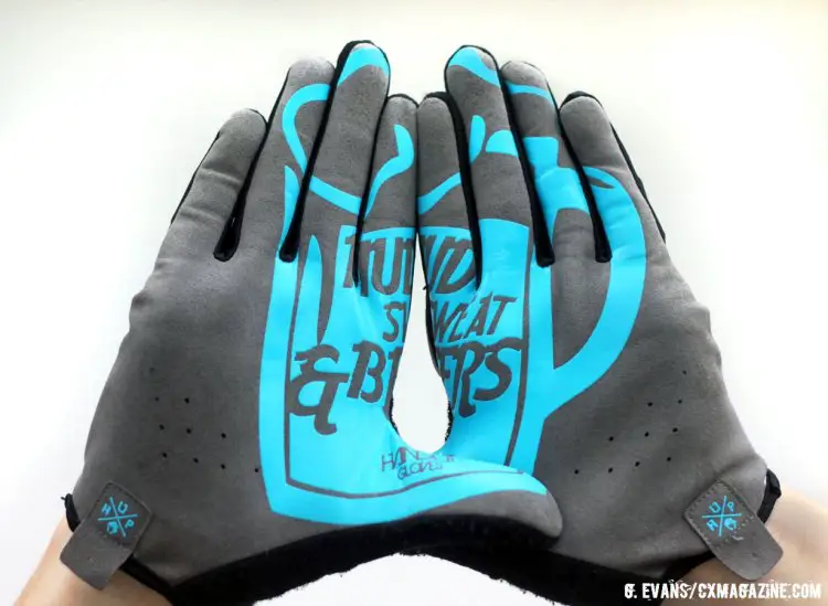 All of the Handup gloves feature a design on the palms that take shape when the hands are held side by side. While not particularly easy to read at a glance, the messages–in this case “Mud Sweat and Beers”–seem fitting to throw up at your local races. © Greg Evans / Cyclocross Magazine