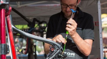 Wolfgang Turainsky tapping out the bubbles, and bleeding the system in just a few minutes. The Uno hydraulic shifting component group from Rotor. © Cyclocross Magazine