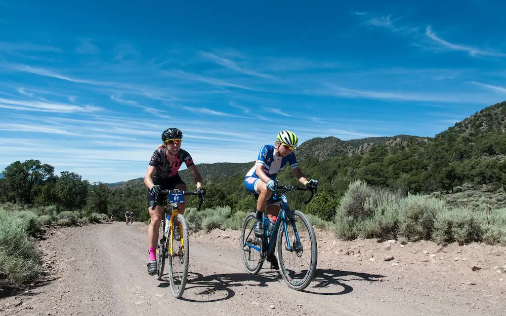 Mindy McCutcheon, left and Robin Farina, right rode side by side for most of the day neither yeilding until the slopes of Col D Crush where McCutheon soloed away for the win. Here the two racers are on Doc Springs Road (also known as the Sarlacc Pit). 2016 Tushar Crusher. Photo courtesy Christopher See