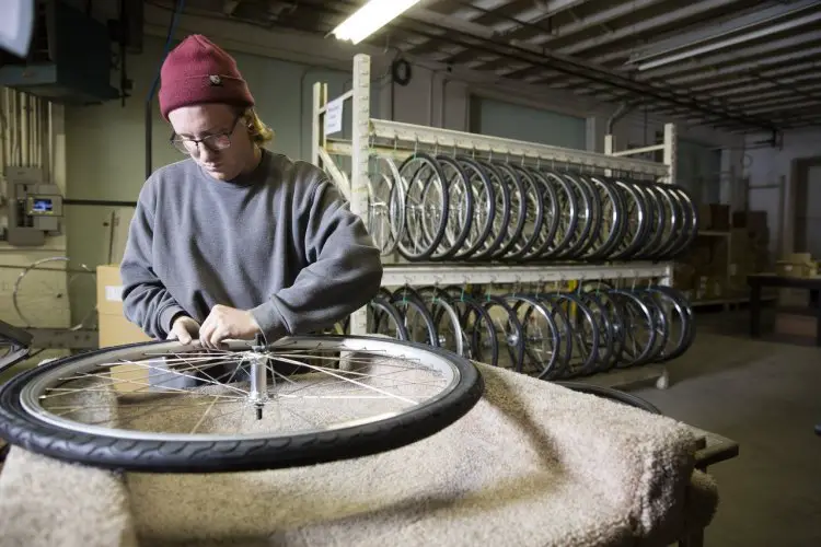 Blake Yard installing the tires on a Detroit-built wheel. photo: courtesy