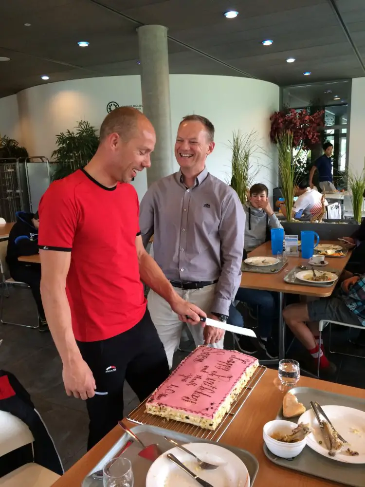 Sven cutting birthday cake with UCI's Peter Van den Abeele. UCI CX Training Camp 5.0. Photo courtesy Geoff Proctor. 