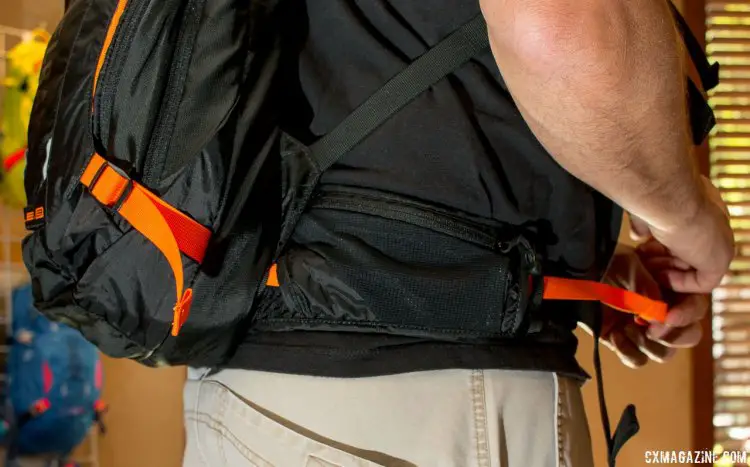 The 15 liter (carrying capacity) $150 Mule LR hip belt's orange straps extend into the pack, allowing you to cinch down the bladder as you empty it. Camelbak, Press Camp 2016. © Cyclocross Magazine