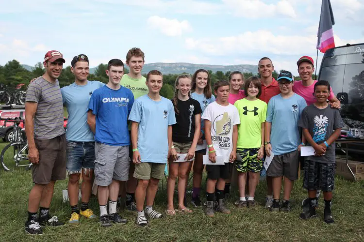 JAM Fund co-founders Alec Donahue (far left) and Jeremy Powers (top row right), pose with the grant recipients at the awards ceremony following the Grand Fundo ride. Grant recipients (from left to right): Ben Jankowski, Patrick Collins, Kale Wenczel, Daniel Vaughn, Mira Fowler, Katherine Johnson, Beau Guenther, Anna Savage, Jonathan Hills, Erik Carlson, Aiden Mapel and Jaden Wise. Chris Novold not pictured. Photo by Meg McMahon.